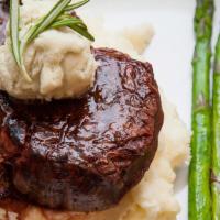 *Filet Mignon · 8 oz. hand-cut beef tenderloin cooked to perfection. Served with grilled asparagus and mashe...