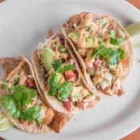 Fish Tacos · Three tacos, fried tilapia, cabbage, cilantro, spicy crema.
