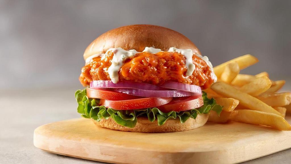 Crispy Buffalo Chicken Sandwich Combo · Southern style breaded chicken breast, tossed in buffalo sauce, topped with chunky blue blue cheese dressing and garnished with lettuce, tomato, and onion. Served with your choice of 1 side and can of soda.