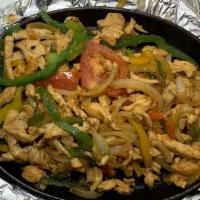 Fajitas · Tender sliced beef or chicken cooked with bell peppers, onions and tomatoes served with refr...