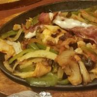 Seafood Fajitas · The perfect combination of shrimp, scallops, grilled onions, tomatoes, green peppers and bro...