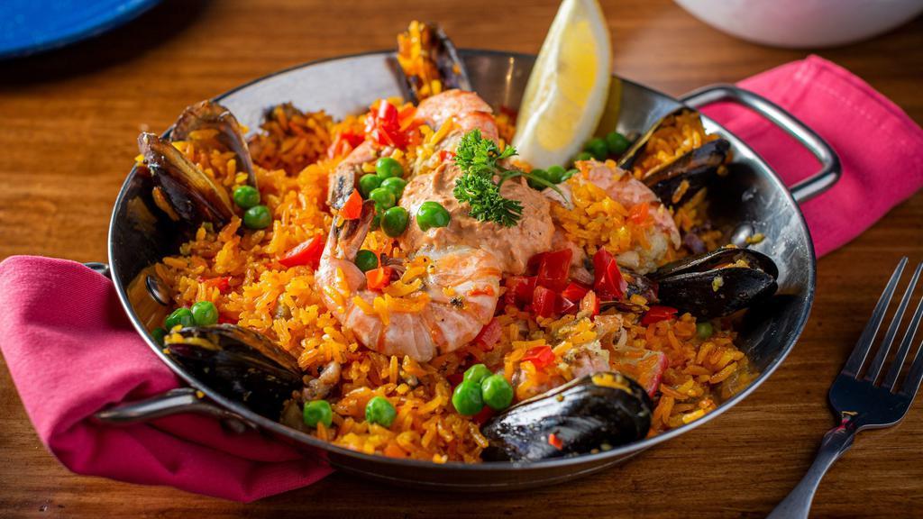 Arroz Con Mariscos · Seafood rice, shrimp, octopus, fish, and langoustines.
