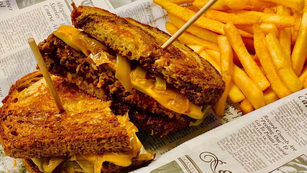 Patty Melt Burger · American and Swiss cheeses & caramelized onions on marble rye bread.