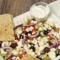 Large Greek Salad · Lettuce, tomatoes, onions, cucumbers, black olives, feta cheese, and cucumber sauce on the s...