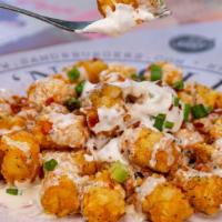 Loaded Tots · Ranch seasoned tots, queso, bacon, green onions, sour cream