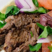 Beef Shawarma Pita · Thinly-sliced marinated beef, sumac onions, tomato, pickled turnips, hummus, rice, and tahini.