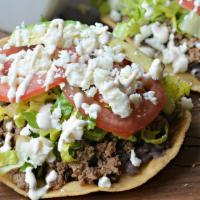 Tostadas · Three crispy tortillas spread with refried beans and topped with your favorite meat. Lettuce...