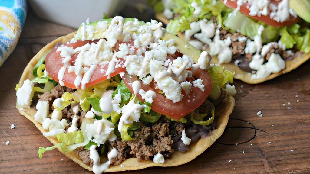 Tostadas · Three crispy tortillas spread with refried beans and topped with your favorite meat. Lettuce, queso fresco, sour cream, pico de gallo and your choice of salsa.