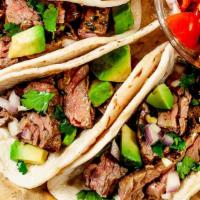 Asada Tacos · 3 Tacos filled with grilled steak, topped with cilantro, onions and your favorite home made ...