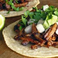 Barbacoa Tacos · 3 Tacos filled with shredded beef, topped with cilantro, onions and your favorite home made ...