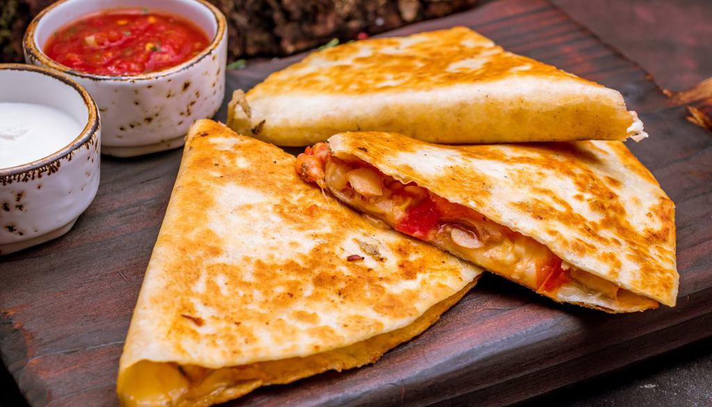 Fajita Quesadilla · Sauteed onions and freshly chihuahua cheese on flour tortillas with sour cream and fresh guacamole with your choice of protein - fajita, chicken or steak.