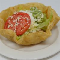 Taco Salad · A crispy flour tortilla with melted cheese sauce topped with seasoned ground beef or shredde...