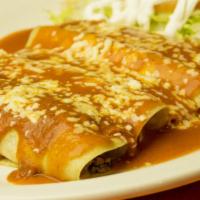 Enchiladas Supremas · Four enchiladas one cheese, one chicken, one bean, one beef topped with red sauce, shredded ...