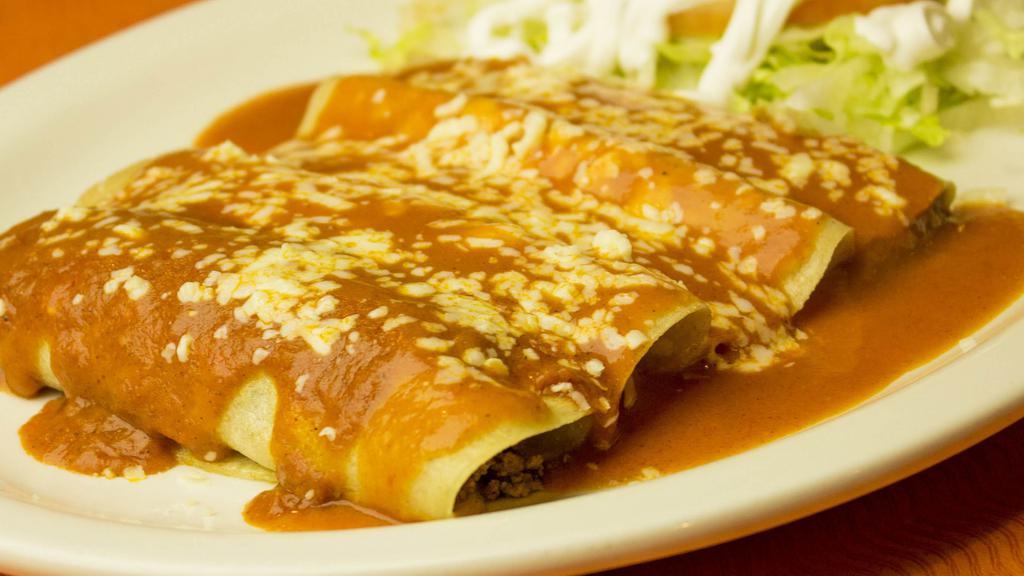 Enchiladas Supremas · Four enchiladas one cheese, one chicken, one bean, one beef topped with red sauce, shredded cheese, lettuce, sour cream, and tomatoes.