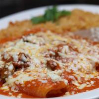 Enchiladas Rancheras · Three cheese enchiladas topped with shredded beef  and enchilada sauce served with rice and ...