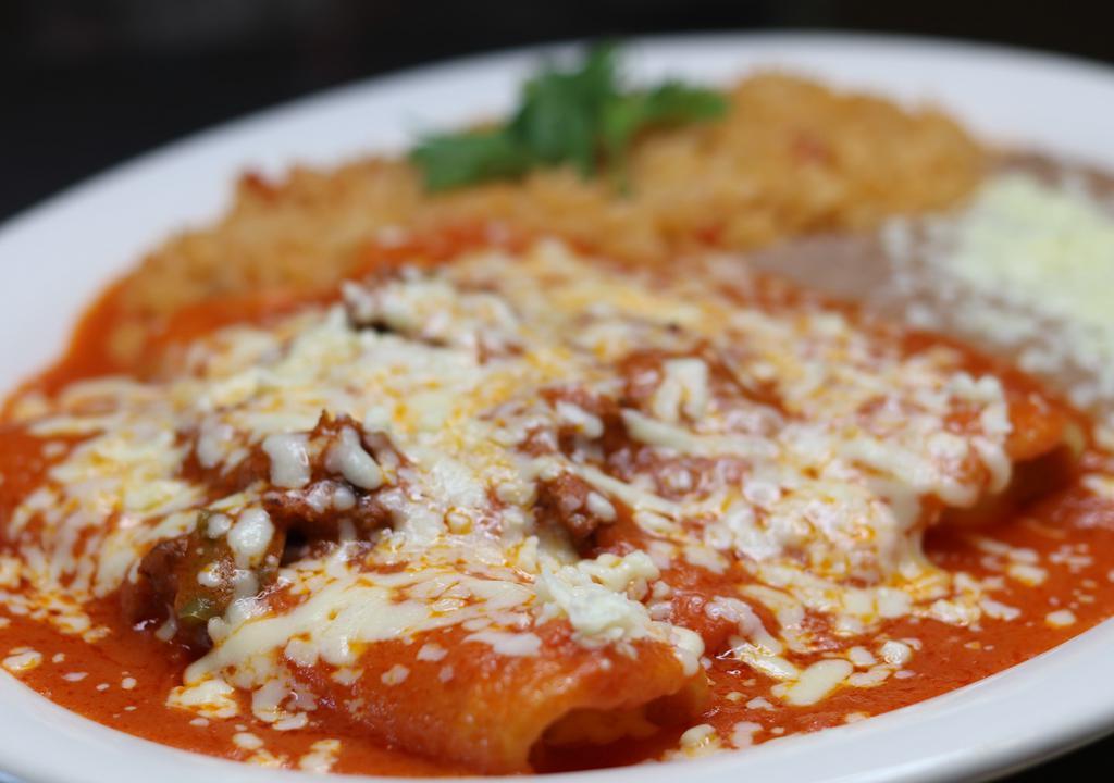 Enchiladas Rancheras · Three cheese enchiladas topped with shredded beef  and enchilada sauce served with rice and beans.