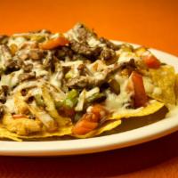 Fajita Nachos · Grilled chicken or steak, onions, tomatoes, bell peppers and cheese sauce.