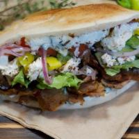 The Original Doner (Pita) · No mystery meat here. Whole protein beef & lamb, marinated and slowly grilled on our vertica...