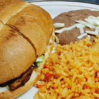 Torta Dinner · Una torta servida con arroz y frijoles. / One torta served with rice and beans.