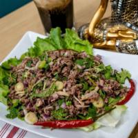 Beef Larb Salad · Beef, tripe, purple onion, rice powder, green onion, cilantro, fish sauce and lime juice.