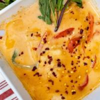 Red Curry · Thai red curry in coconut milk with bamboo shoots & bell peppers with sweet basil.