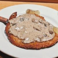 Schnitzel Dinner · half pound pork schnitzel topped With triple mushroom sauce and one side.