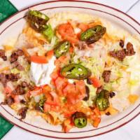 Grand Nachos · Hot chips piled high with refried beans, ground beef or shredded chicken, nacho cheese sauce...
