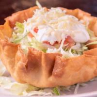 Beef Taco Salad · Piled high with refried beans, then topped with lettuce, cheese, tomatoes, onions, sour crea...