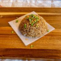 Garlic Fried Rice · Topped with toasted garlic.