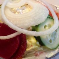 Our Famous Greek · Lettuce, tomatoes, onions, cucumber, beets, Greek olives, pepperoncini and feta cheese cover...