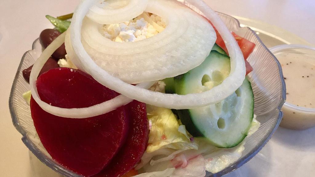 Our Famous Greek · Lettuce, tomatoes, onions, cucumber, beets, Greek olives, pepperoncini and feta cheese covered with our delicious Greek dressing.