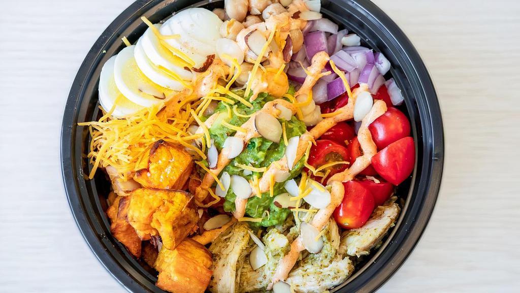 Protein Bowl · Brown rice, honey mustard chicken, sweet potatoes, cherry tomatoes, chickpeas, red onions, cheddar cheese, hard boiled egg, almonds & guac - topped with creamy sriracha dressing