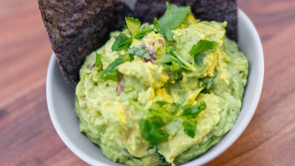 Classic Guac · Avocado, cilantro, garlic, onion, salt, pepper & lime juice. Served with chips