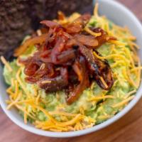 Caramelized Onion & Cheddar Guac · Classic guac topped with caramelized onions & shredded cheddar cheese.  Served with chips