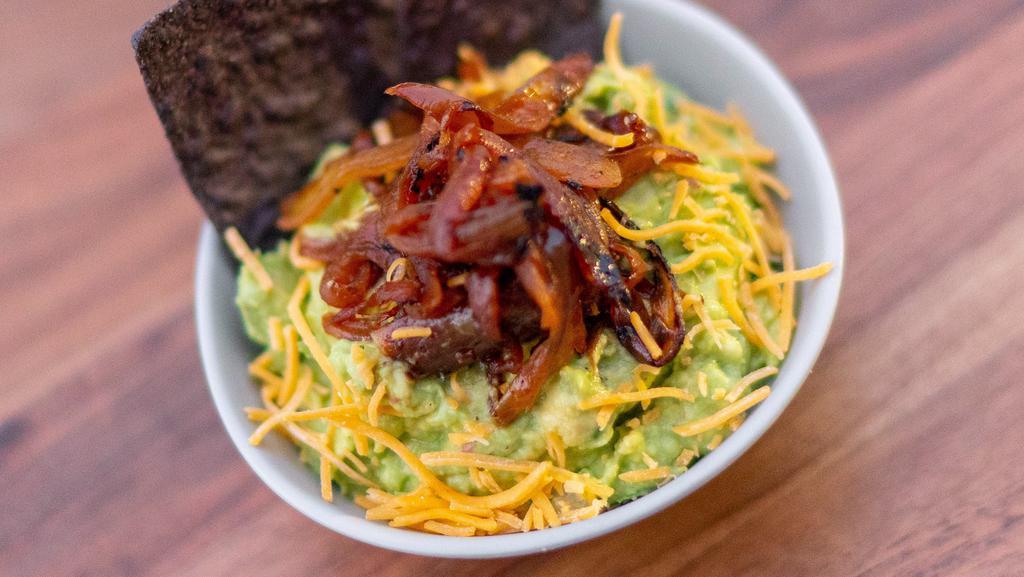Caramelized Onion & Cheddar Guac · Classic guac topped with caramelized onions & shredded cheddar cheese.  Served with chips