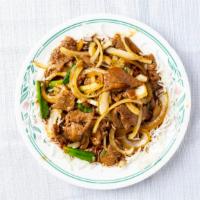 Mongolian Beef · stir fry beef with white and green onions over a bed of crunchy rice sticks