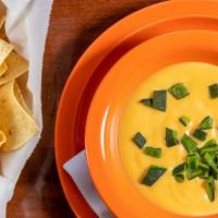 Queso Dip · White cheddar cheese with poblano peppers. Comes with Chips.