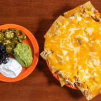 Nachos Gringos Half · Tortilla chips topped with beans and cheese. Sour cream, jalapeños, guacamole, and black oli...