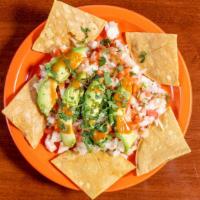 Shrimp Ceviche · Shrimp marinated in lime juice with cilantro, onions, tomatoes. Garnished with avocado and a...