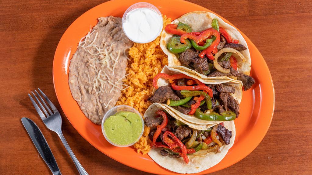 Tacos A La Plancha (3) · Grilled steak OR chicken with onions, and green and red bell peppers. Comes with a side of guacamole and sour cream. Served with rice & beans.