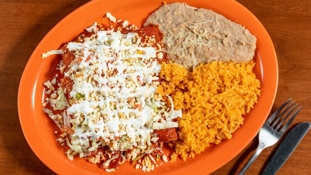 Enchiladas Rancheras (3) · Enchiladas covered with chile guajillo topped with lettuce, tomatoes, shredded anejo cheese, and sour cream.