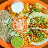 Fish Tacos · Tilapia fish grilled with chopped bell peppers, onions, and rice. Comes with rice & beans.