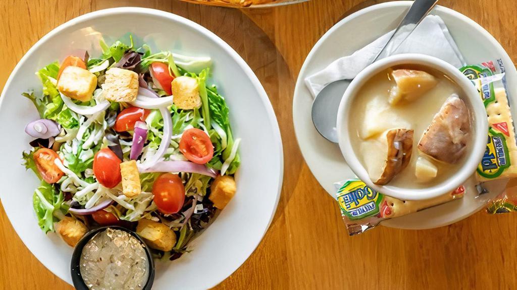 Cup Of Soup & Small House Salad · Organic spring & romaine mix w/ grape tomatoes, red onions, mozzarella, & croutons.