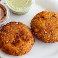 Aloo Tikki · Two pieces of flavored potatoes patties served with sauce.