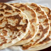 Plain Naan · Freshly baked unleavened bread.