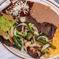 Tampiquena · Skirt steak served with one mole enchilada, guacamole, rice and beans. Grilled onions and ja...