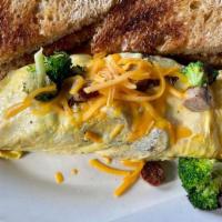 Combo No.5 – Gyro Omelet · Three farm fresh eggs, gyro meat, fresh spinach, tomatoes, onions, Swiss cheese, topped with...