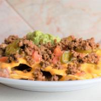 Nachos · A bed of tortilla chips, Beans, nacho cheese, jalapeños, pico de gallo, guacamole and your c...