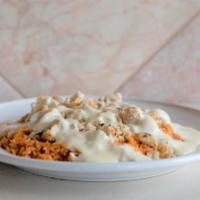 Arroz Con Pollo · A bed of rice with chicken and queso dip on top