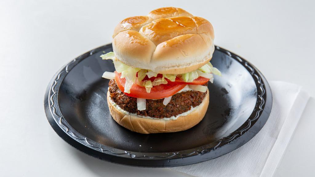 Falafel Burger · Vegetarian. Fried quarter-pound falafel patty served on a toasted bun topped with lettuce, tomato, onion and our homemade tzatziki sauce. Get any sandwich in a basket, includes fries, onion rings, and coleslaw.
